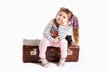 Beautiful toddler girl sitting on retro suitcase Royalty Free Stock Photo