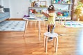 Beautiful toddler standing playing with chocolate colored balls on the table at kindergarten Royalty Free Stock Photo