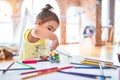 Beautiful toddler standing playing with chocolate colored balls on the table at kindergarten Royalty Free Stock Photo