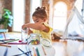 Beautiful toddler standing playing with chocolate colored balls on the table at kindergarten Royalty Free Stock Photo