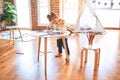 Beautiful toddler standing playing with chocolate colored balls on the table at kindergarten Royalty Free Stock Photo