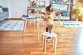 Beautiful toddler standing playing with chocolate colored balls on the table at kindergarten Royalty Free Stock Photo