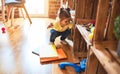 Beautiful toddler taking books of shelving at kindergarten