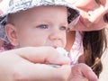 Beautiful toddler walking with his mother on a city holiday. Boy eating soup sour cream the street. Kid stylishly Royalty Free Stock Photo