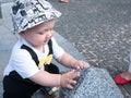 Beautiful toddler walking with his mother on a city holiday. Kid stylishly dressed butterfly and cap Royalty Free Stock Photo