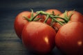 Beautiful tomatoes on a wooden background