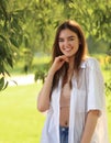 Beautiful toothy smiling teen woman looking happy outdoors summer green trees background. Closeup portrait Royalty Free Stock Photo