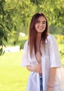 Beautiful toothy smiling teen woman looking happy outdoors summer green trees background. Closeup portrait Royalty Free Stock Photo