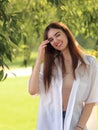 Beautiful toothy smiling teen woman looking happy outdoors summer green trees background. Closeup portrait Royalty Free Stock Photo