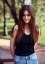 Beautiful toothy smiling teen woman looking happy outdoors on summer green trees background. Closeup portrait in bright sunny day Royalty Free Stock Photo