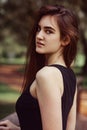 Beautiful toothy smiling teen woman looking happy outdoors on summer green trees background. Closeup portrait in bright sunny day Royalty Free Stock Photo