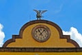 Beautiful top of the building with clock on the facade blue sky view