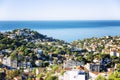 Beautiful top view of a European city on the coast of the sea. White houses with orange roofs, bright blue sky on a sunny day. Royalty Free Stock Photo