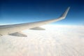 Beautiful top view from passenger supersonic airplane window flying high above white clouds in the sky