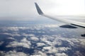 Beautiful top view from passenger supersonic airplane window flying high above white clouds in the sky Royalty Free Stock Photo