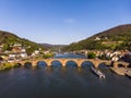 Beautiful top view of the pedestrian bridge over the river and the old part of the city. Spring. Green leaves on the trees. Royalty Free Stock Photo