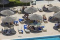 Beautiful top view of tourists resting under sun loungers in hotel near pool. Rhodes.