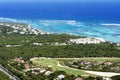 Beautiful top view: turquoise Caribbean Sea, sandy beach, palm grove, hotels on a bright sunny day. Royalty Free Stock Photo