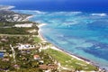 Beautiful top view: turquoise Caribbean Sea, sandy beach, palm grove, hotels on a bright sunny day. Royalty Free Stock Photo