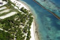 Beautiful top view: turquoise Caribbean Sea, sandy beach, palm grove, hotels on a bright sunny day. Royalty Free Stock Photo