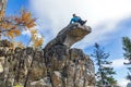 beautiful tourist admires the beauty of the South Urals on the rocks of the summit of Mount Malinovoye on an autumn day