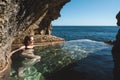 Female Tourist Bathing in Natural Pool at Peguyangan Waterfall in Nusa Penida Island, Bali, Indonesia