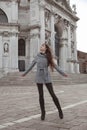 Beautiful tourist girl visiting famous landmark of Basilica Santa Maria della Salute, Venice, Italy Royalty Free Stock Photo