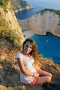 Beautiful tourist at Navagio beach, Zakynthos Island, Greece