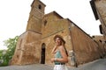 Beautiful tourist woman in front of the old church of San Giovenale former Cathedral of Orvieto, Umbria, Italy Royalty Free Stock Photo