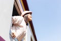 Beautiful tourist woman is inhaling fresh air during the train running to destination.