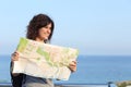 Beautiful tourist woman on vacation with a city map