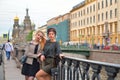 Beautiful tourists rest at the gate of the Griboyedov Canal emba Royalty Free Stock Photo