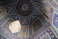 Beautiful traditional blue decorated ceilings of mosques of Iran with a rich chandelier