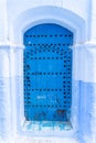 Traditional Moroccan blue door in Chefchaouen, the Blue Pearl of Morocco Royalty Free Stock Photo