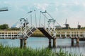 Beautiful traditional dutch windmills near the water channels with drawbridge Royalty Free Stock Photo