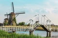 Beautiful traditional dutch windmills near the water channels with drawbridge Royalty Free Stock Photo