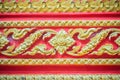 Beautiful traditional golden Thai style stucco patterned for decorative on wall background at Buddhist temple in Thailand. Royalty Free Stock Photo