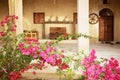 Beautiful traditional house with beautiful pink flowers in the garden and wooden doors and windows. Qeshm, Iran.