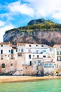 Beautiful traditional houses on the coast of Tyrrhenian sea in Cefalu, Sicily, Italy. Behind the buildings magnificent rock Royalty Free Stock Photo