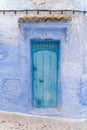 Traditional Moroccan pale blue door with canopy in Chefchaouen, the Blue Pearl Morocco Royalty Free Stock Photo