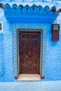 Traditional Moroccan door with canopy in Chefchaouen, the Blue Pearl Morocco Royalty Free Stock Photo