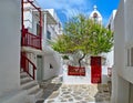 Beautiful traditional narrow cobbled streets, small squares of Greek island towns. Whitewashed houses. Small chapel and Royalty Free Stock Photo