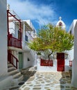Beautiful traditional narrow cobbled streets, small squares of Greek island towns. Whitewashed houses. Small chapel and Royalty Free Stock Photo