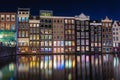 Beautiful traditional old buildings on canal in Amsterdam at night Royalty Free Stock Photo