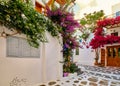 Beautiful traditional streets of Greek island towns. Whitewashed houses, rich bougainvillea in blossom, cobblestone