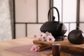 Beautiful traditional tea ceremony set and sakura flowers on wooden table. Space for text Royalty Free Stock Photo