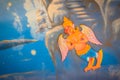 Beautiful traditional Thai style angels painting of folk literature on the ceiling at public Buddhist temple in Thailand.