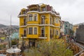 Beautiful traditional yellow wooden building in Valparaiso, Chile