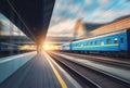 Beautiful train with blue wagons in motion at the railway statio Royalty Free Stock Photo