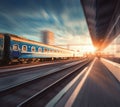 Beautiful train with blue wagons in motion at the railway statio Royalty Free Stock Photo